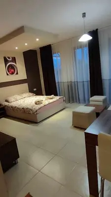 a bedroom with a bed and a table in it at Crystal Apartment Bansko in Bansko