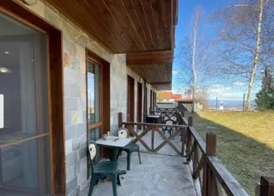 a porch of a house with a table and a grill at Crystal Apartment Bansko in Bansko