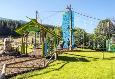 a playground in a park with a roller coaster at Crystal Apartment Bansko in Bansko