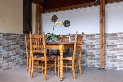 a wooden table with chairs and a plant on it at Villa Veselina Loft Studios in Hisarya