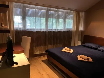 a bedroom with a bed with two towels on it at Panorama Apartment in Pamporovo