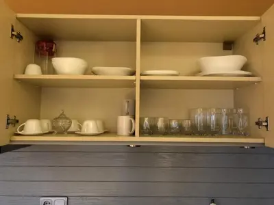 a shelf with dishes and other items on it at Panorama Apartment in Pamporovo