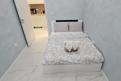 a small bedroom with a bed with shoes on it at Urban Stay Sofia in Sofia