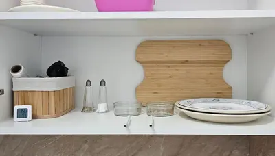a white shelf with a plate and bowls on it at Urban Stay Sofia in Sofia