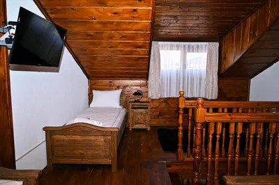 a room with a bed and a television in a house at Къща Джано in Dobrinishte