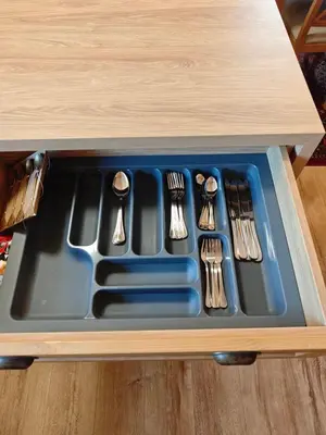 a tray of utensils in a wooden drawer at Apartment 78 by the pool in Bansko