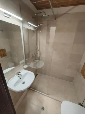 a bathroom with a sink and a shower at Apartment 78 by the pool in Bansko