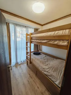 a bedroom with two bunk beds and a window at Apartment 78 by the pool in Bansko