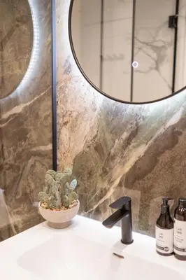 a bathroom sink with a mirror and a plant at Amber Corner I Brand New Flat Top Location in Sofia