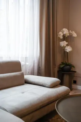 a couch in a living room with a window at Amber Corner I Brand New Flat Top Location in Sofia