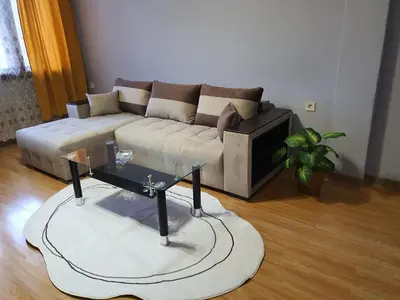 a living room with a couch and a glass table at TONI'S Apartament in Bŭnzareto