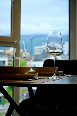 a table with two wine glasses on top of it at Eleve Residences - Stone Studios in Sofia
