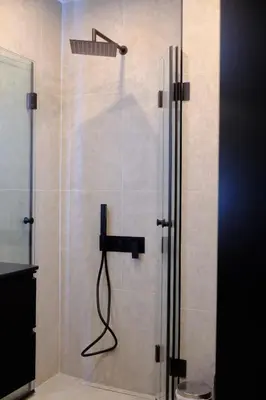 a shower in a bathroom with a glass door at Eleve Residences - Stone Studios in Sofia