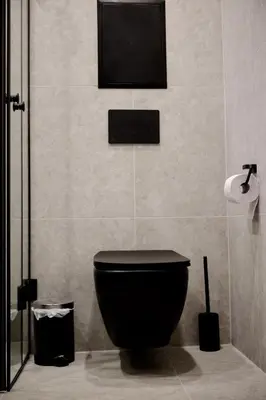 a bathroom with a toilet and a tv on the wall at Eleve Residences - Stone Studios in Sofia