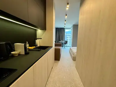 a hotel room with a kitchen and a living room at Eleve Residences - Stone Studios in Sofia