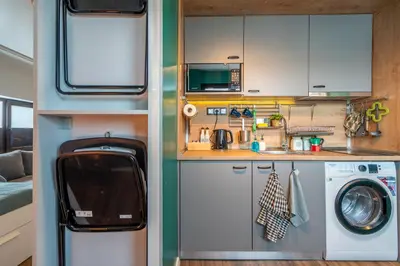 a small kitchen with a sink and a washing machine at Leafy Loft in Sofia