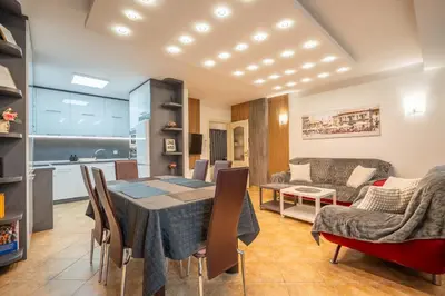 a dining room and living room with a table and chairs at Marble place in Sofia