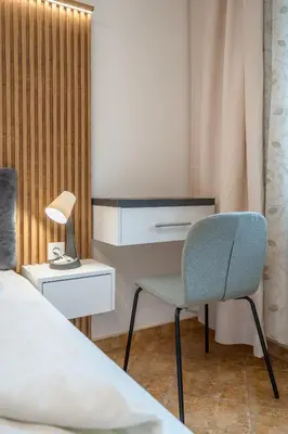 a bedroom with a bed and a chair and a desk at Marble place in Sofia