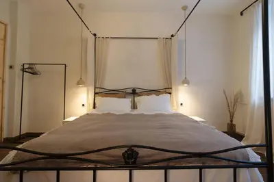 a bedroom with a bed with a wrought iron headboard at Stylish Retreat in Sofia in Sofia