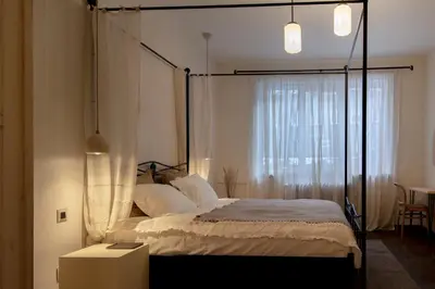 a bedroom with a canopy bed with a window at Stylish Retreat in Sofia in Sofia
