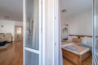 a bedroom with a bed and a living room at Spacious 1 bedroom apartment in a lively center in Sofia