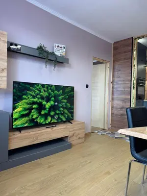 a living room with a flat screen tv on a wall at VeliApartmets in Velingrad