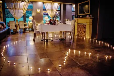 a dining room with a table with lights on the floor at Ski Retreat Spa Pool and Mountain Views in Bansko
