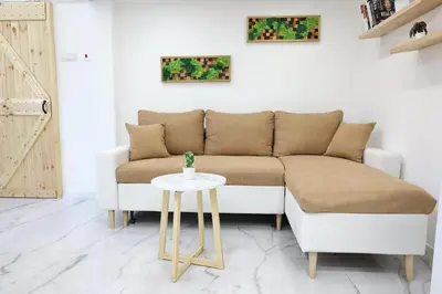 a living room with a couch and a table at Free parking, Close to Subway, Central location in Sofia