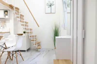 a white living room with a staircase and white chairs at Free parking, Close to Subway, Central location in Sofia