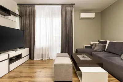 a living room with a couch and a tv at 1BD Flat in Plovdiv - 25 min Walk from the Centre by Flat Mаnаger in Plovdiv