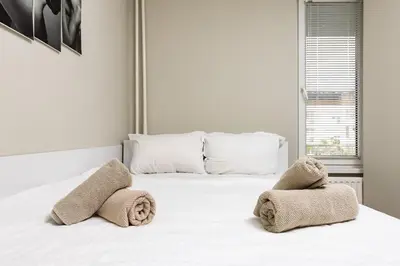 a bedroom with a white bed with towels on it at 1BD Flat in Plovdiv - 25 min Walk from the Centre by Flat Mаnаger in Plovdiv