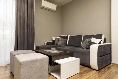 a living room with a couch and a table at 1BD Flat in Plovdiv - 25 min Walk from the Centre by Flat Mаnаger in Plovdiv