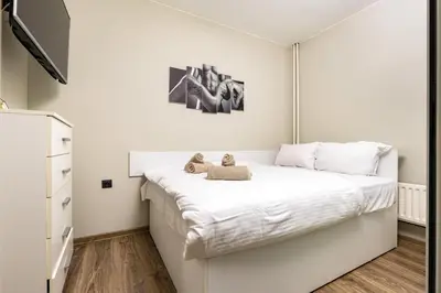 a bedroom with a white bed with two teddy bears on it at 1BD Flat in Plovdiv - 25 min Walk from the Centre by Flat Mаnаger in Plovdiv