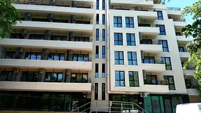 a tall white apartment building with balconies at Hotel Rooms St Paul in Plovdiv