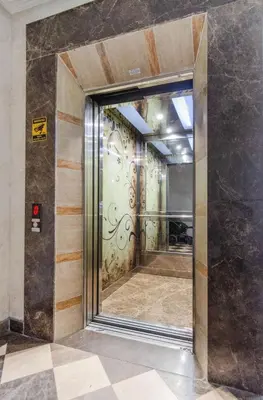 an elevator door in a building with a mirror at Hotel Rooms St Paul in Plovdiv