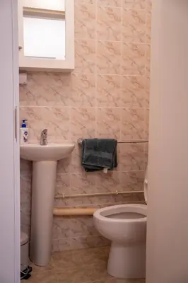 a bathroom with a sink and a toilet and a window at Center and Old Town Apartment in Plovdiv