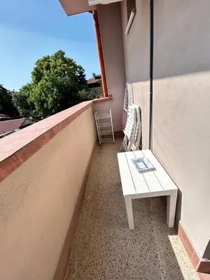 a white bench sitting on a balcony with a window at Center and Old Town Apartment in Plovdiv