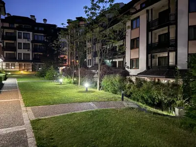 a park in front of a building at night at Downtown Bansko Luxury Resort in Bansko