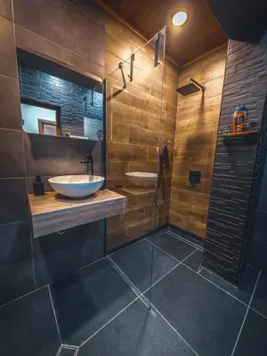 a bathroom with a sink and a glass shower at Апартамент Петя 2 in Velingrad