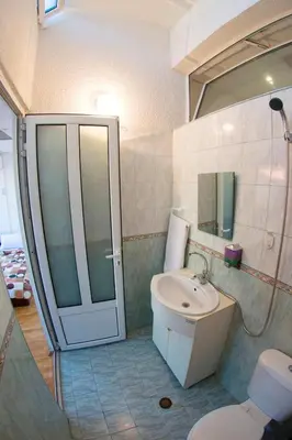 a bathroom with a toilet and a sink and a shower at Sofia Central Guest Rooms in Sofia