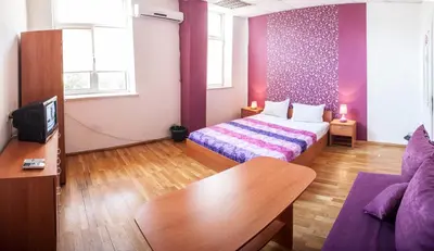 a small room with a bed and a couch at Sofia Central Guest Rooms in Sofia