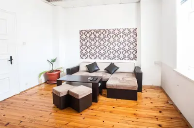 a living room with a couch and a table at Sofia Central Guest Rooms in Sofia