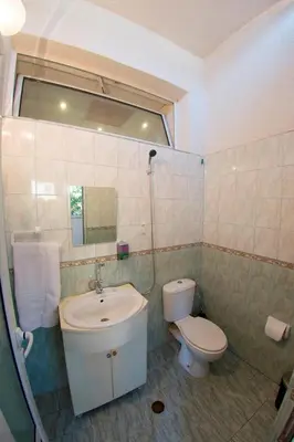 a bathroom with a sink and a toilet and a mirror at Sofia Central Guest Rooms in Sofia