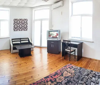 a living room with a couch a table and a tv at Sofia Central Guest Rooms in Sofia