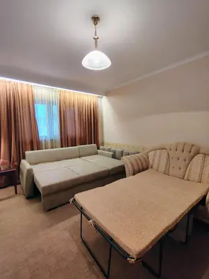 a living room with a couch and a table at 3 Rooms Apartment next to the Ski lift in Bansko