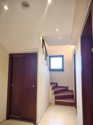 a hallway with a door and stairs in a building at 3 Rooms Apartment next to the Ski lift in Bansko