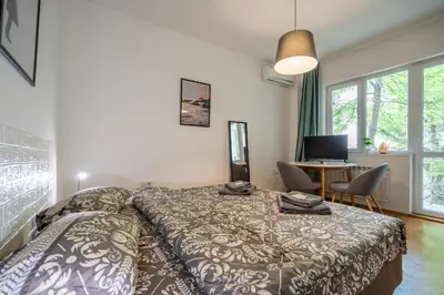 a bedroom with a bed and a desk with a computer at Central Sofia Gem by Vitoshka Street in Sofia
