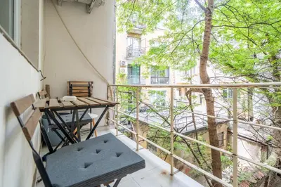 a small balcony with a table and a chair at Central Sofia Gem by Vitoshka Street in Sofia