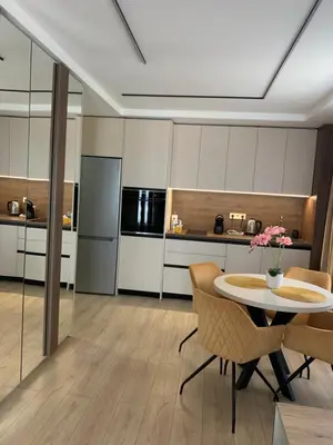 a kitchen with a table and chairs in a room at The Modern Nest Apartment with FREE Underground Parking in Plovdiv
