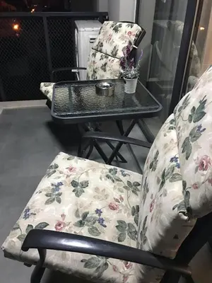 a table and two chairs with flowers on them at The Modern Nest Apartment with FREE Underground Parking in Plovdiv